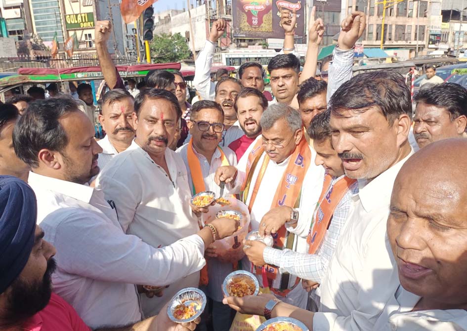 Celebrations at the Clock Tower following BJP's electoral victory; party workers distributed sweets and Jhal Muri.